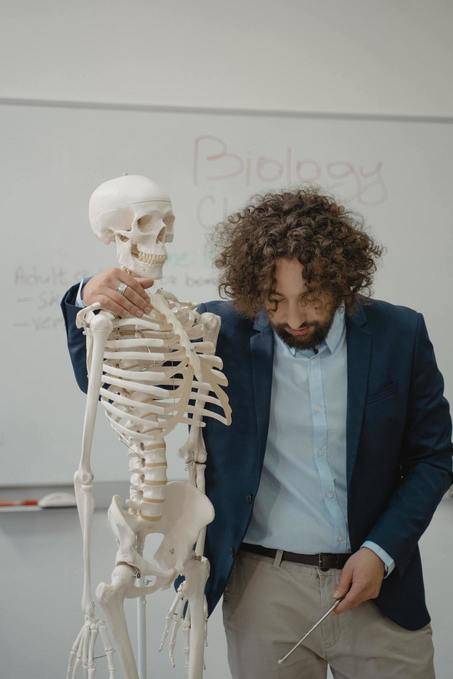 A teacher with holding a skeleton